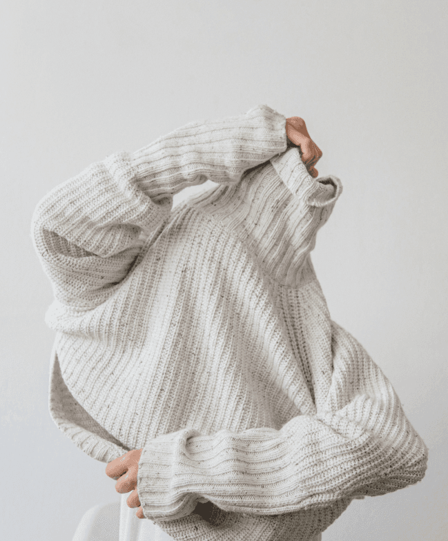 A model in a cream knit sweater